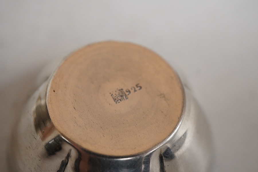 An Italian pierced 900 standard white metal bottle coaster, diameter 99mm, together with a sterling cream jug and a small 925 bowl, 9.9oz.